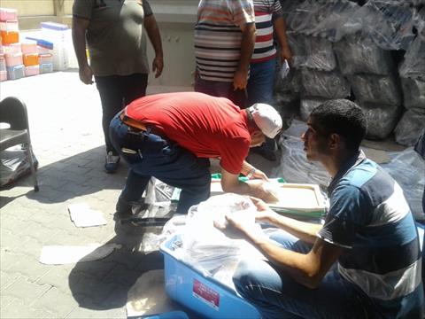 افراد الامن اثناء فض محتويات الحاوية