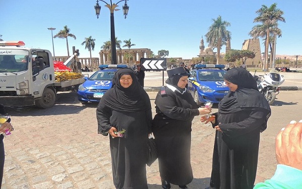 الشرطة بأسيوط والأقصر توزع الورود والهدايا على المواطنين احتفالا بعيدها الـ